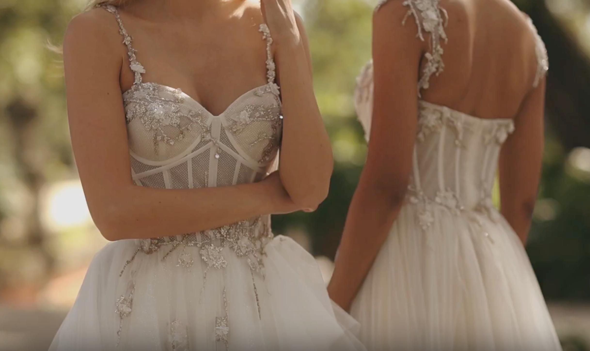 two women wearing wedding dresses